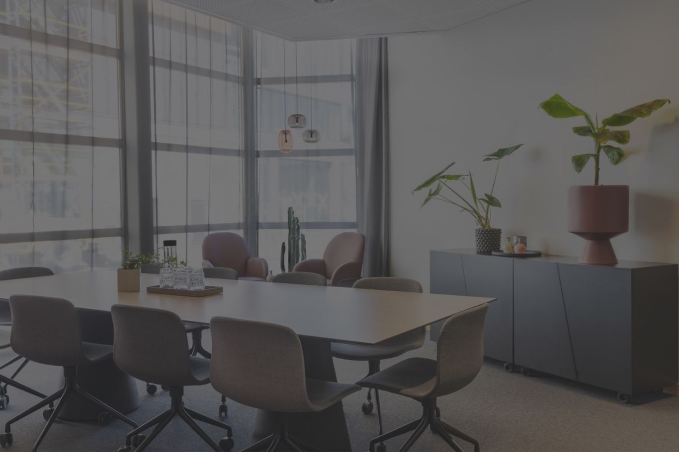 Brightly lit meeting room with chairs around a table 